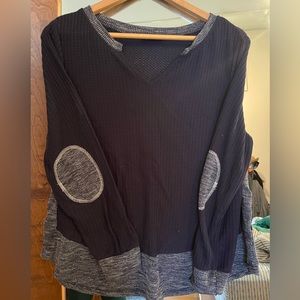 Casual waffle knit top with elbow patch details.